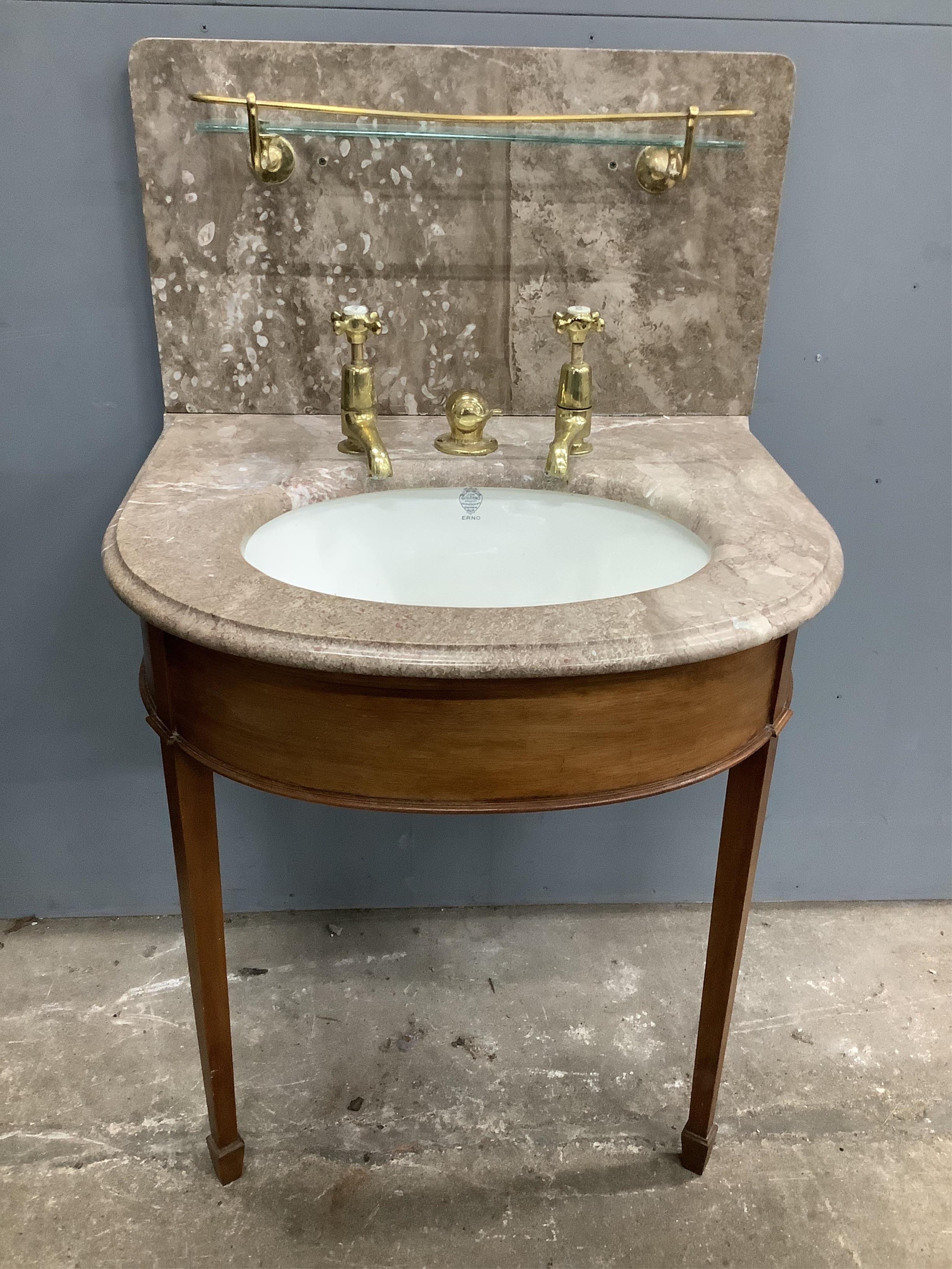 A marbled topped mahogany wash basin with John Bolding & Sons Erno ceramic basin and brass metal work, width 69cm, height 117cm. Condition - two old repair cracks to the marble top near front right, otherwise fair